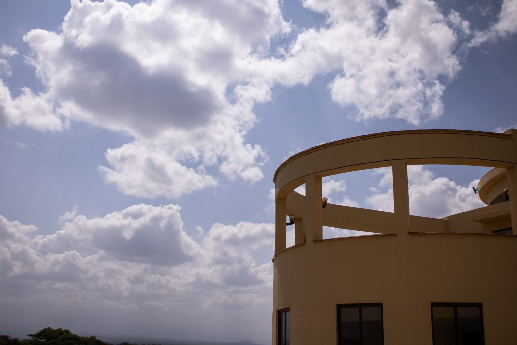 Exterior view of the open-air Anga Sky Bar terrace showcasing elevated architecture against a cloud-filled sky.