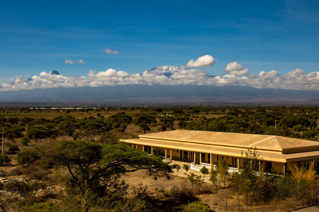 Elevated landscape view of the main conference rooms set against the Amboseli savannah and snow-capped Mount Kilimanjaro.